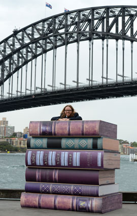 Tim atop the books at the Sydney Media Launch, October 2014 - Photo by James Morgan